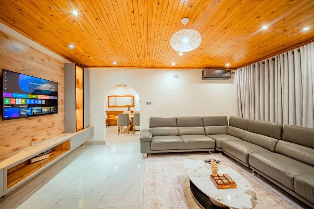 A bright living room with a soft grey sofa and plants
